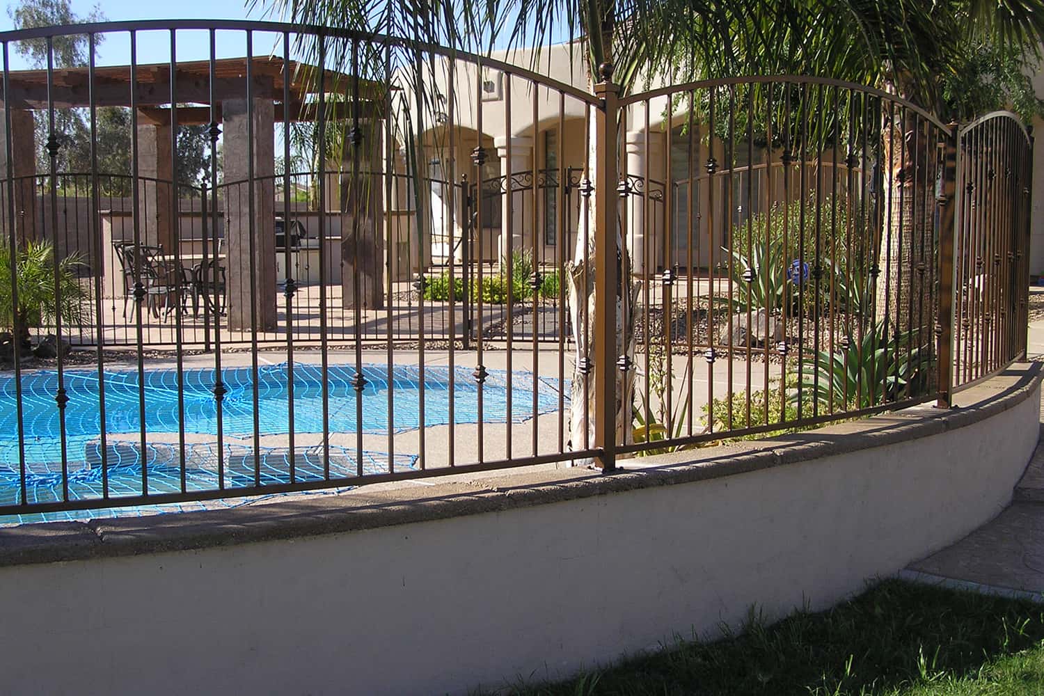 Decorative Arched Fencing on a Masonry Pony Wall